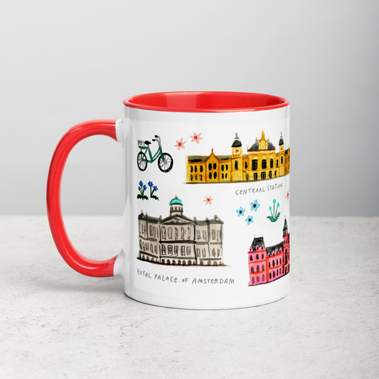 White ceramic coffee mug with orange handle and inside; has Amsterdam illustration by Angela Staehling