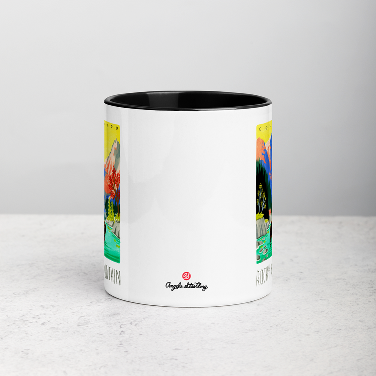 White ceramic coffee mug with black handle and inside; has Rocky Mountain National Park illustration by Angela Staehling