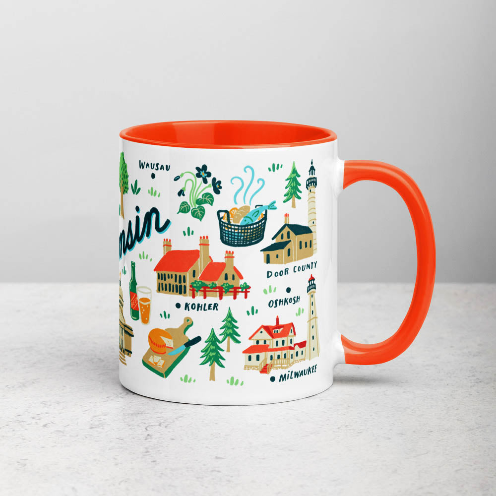 White ceramic coffee mug with orange handle and inside; has Wisconsin illustration by Angela Staehling